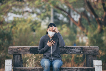 Fototapeta premium woman wearing a mask vent the outbreak of the virus concept for environmental pollution and health,medical.Insurance for your healthcare,disease,dust,smoke,dirt,wildfirein the city