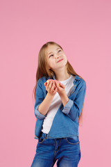 girl playing with a donut on a pink background.