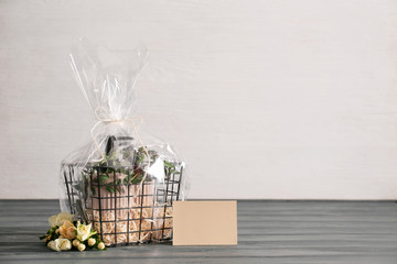 Basket with gifts for Mother's Day on table