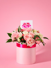 Box with flowers for Mother's Day on color background