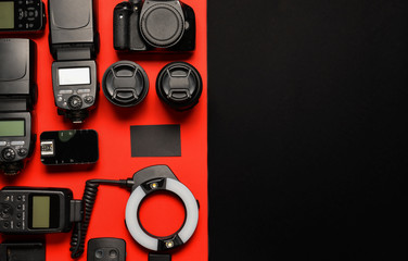 Modern photographer's equipment with card on color background