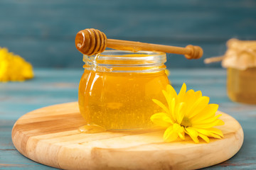 Jar of sweet honey on table