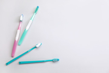 Tooth brushes with paste on light background