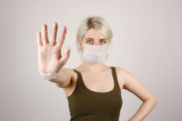 A girl with a mask and gloves to protect her from the crown virus. Corona virus pandemic. Close-up.