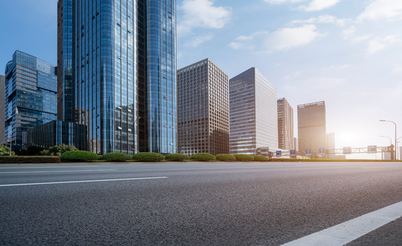 Asphalt road and Ningbo Financial District building office building..