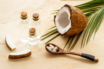 Coconut cosmetics. Organic oil in small bottles on beige background