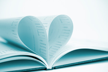The form of heart concept contains from two diary pages with dates that becomes one heart shape. Clean and blurred background.