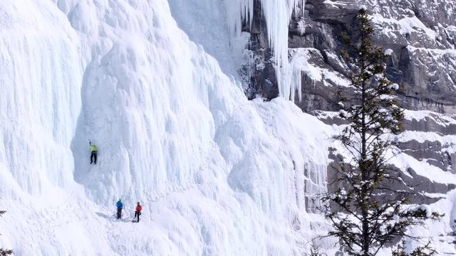 Lead ice climber in shaded dihedral on second pitch of Weeping Wall