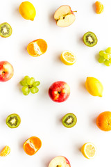 Colorful fruit pattern. Cut apple, kiwi, citrus on white background top-down