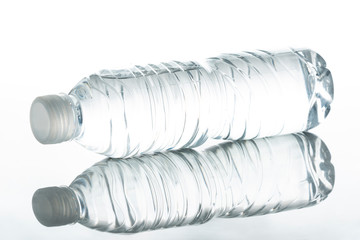A plastic bottle and a glass bottle