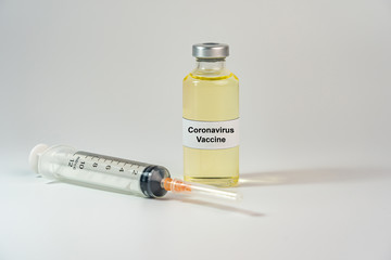 Bottles of Coronavirus vaccine on white background with syringe injection