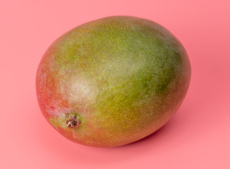 Ripe mango isolated on a pink background.