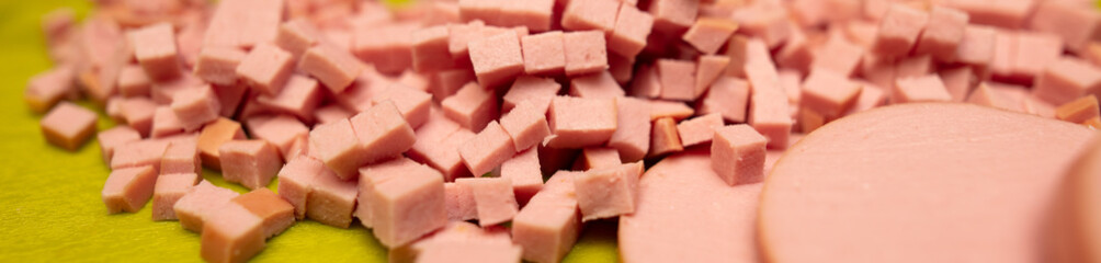 Sliced sausage on a plastic board.