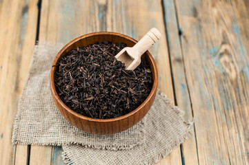 close-up of dry chinese tea in woonden bowl