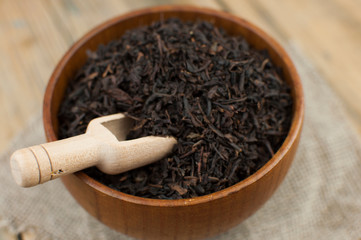 close-up of dry chinese tea in woonden bowl