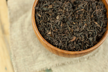 close-up of dry chinese tea in woonden bowl