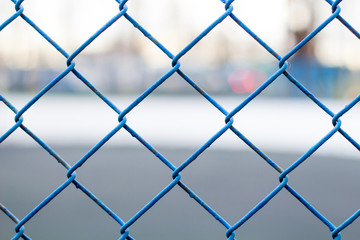 Fototapeta premium Fence on the sky, blue mesh fence, chain link fence Soft focus.