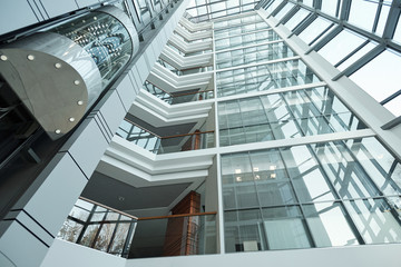 Part of interior of contemporary office center with elevator and balconies