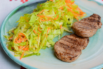 Grilled juicy steak with vegetable salad and herbs. Concept for a tasty and healthy meal.