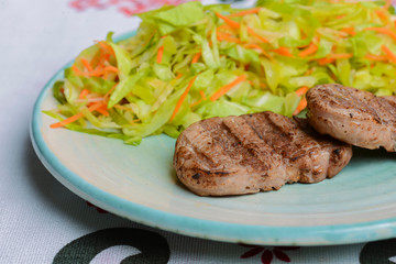 Grilled juicy steak with vegetable salad and herbs. Concept for a tasty and healthy meal.