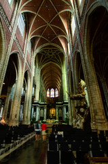 Fototapeta premium Ghent, Belgium, August 2019. Interior view of the Cathedral of San Bavo. We are impressed by the height and the slender lines of the pointed arch vaults. Red bricks.