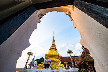 Thai style door frame with golden pagoda in Pong Sanuk temple