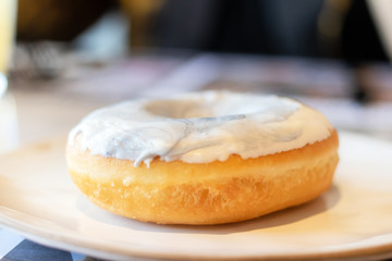 Delicious donuts with a filling and blue glaze on dish.  