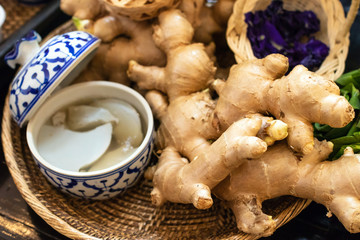Fresh ginger on weave threshing basket ingredients used in herbal medicine.
