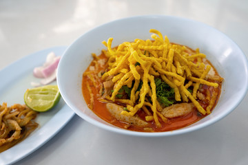Khao Soi or Northern Thai Curry Noodles with Chicken and Side Dishes Is a street food and popular local food in northern Thailand.