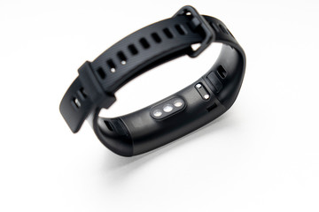 Obraz premium black fitness tracker on a white background, selective focus