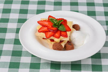 Cake of puff pastry with strawberry. Tasty delicious sweet Italian dessert with strawberry, cream served in white plate