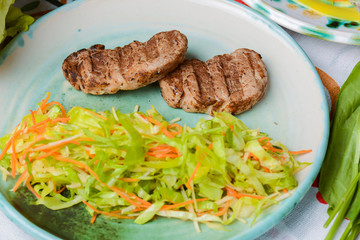 Grilled juicy steak with vegetable salad and herbs. Concept for a tasty and healthy meal.