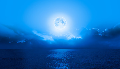 Night sky with full moon in the clouds  "Elements of this image furnished by NASA"