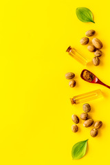 Nutmeg oil - aromatherpy concept - on yellow background top-down copy space