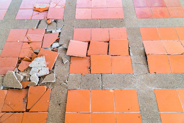 Floor tile damaged texture background. Tiled floor broken and cracked from earthquake surface textured