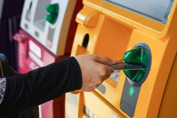 Woman's hand using Credit Card to withdrawing or transfer money from Atm machine.Finance, money,...