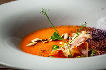 Pumpkin soup with bacon, rustic background. healthy food