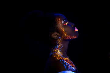 unusual portrait of beautiful african fashion woman in neon UF light. attractive young model girl...