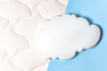 White air cloud on a comfortable mattress texture background and blue background top view. White...