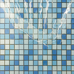 A swimming pool floor tiles on a sunlight