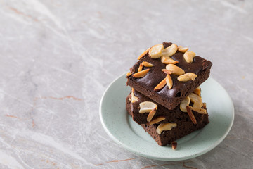 Chocolate brownie cake sprinkle with almonds and cashews.