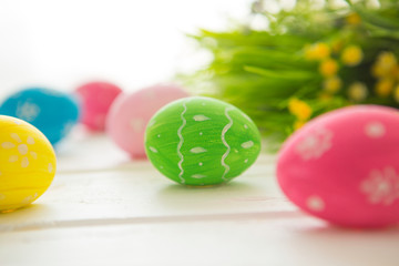 Fototapeta na wymiar Easter eggs on a white wooden surface