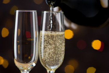 Close-up of champagne pouring in a wine glass