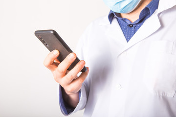 The concept of helping mobile devices in the provision of medical services. Doctor works in a phone on a white background. Copy space