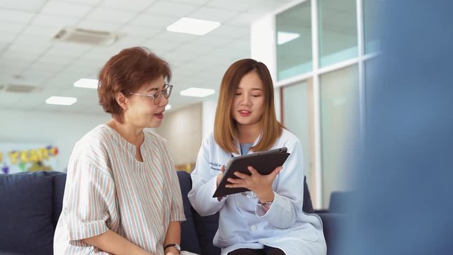 Young doctor consulting senior patient at health care clinic 