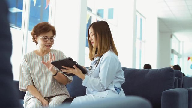 Young doctor consulting senior patient at health care clinic 