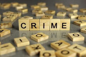 word crime made of square wooden letters on a gray background