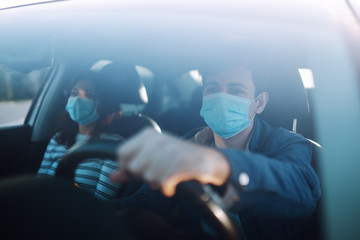 Boy and girl wear protective sterile medical mask in the car. The concept of preventing the spread...
