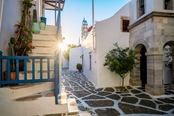 Picturesque scenic narrow streets with traditional whitewashed houses with blue doors windows of Mykonos Chora town in famous tourist attraction Mykonos island, Greece - obrazy, fototapety, plakaty