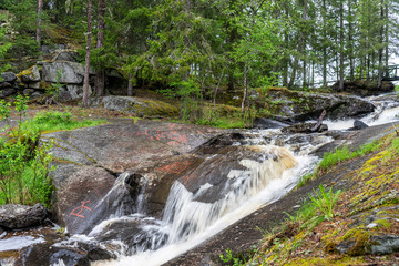 Old rock carving from the stone age by a  small creek in Sweden